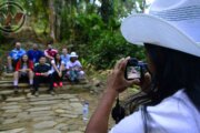 Indigenous Guide Photographing Travelers in the Lost City